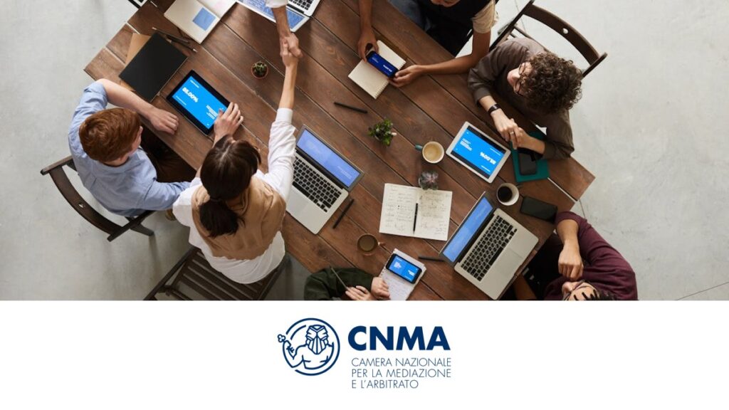 Riunione di lavoro tra professionisti con stretta di mano, logo CNMA